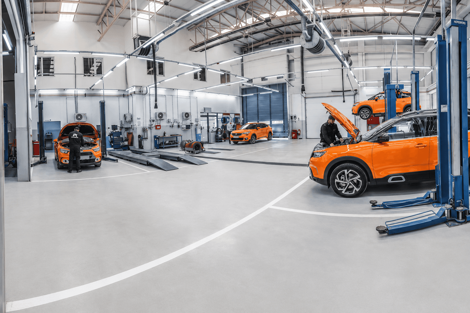 Technicians restoring vehicles inside the Maple Refinish Centre workshop