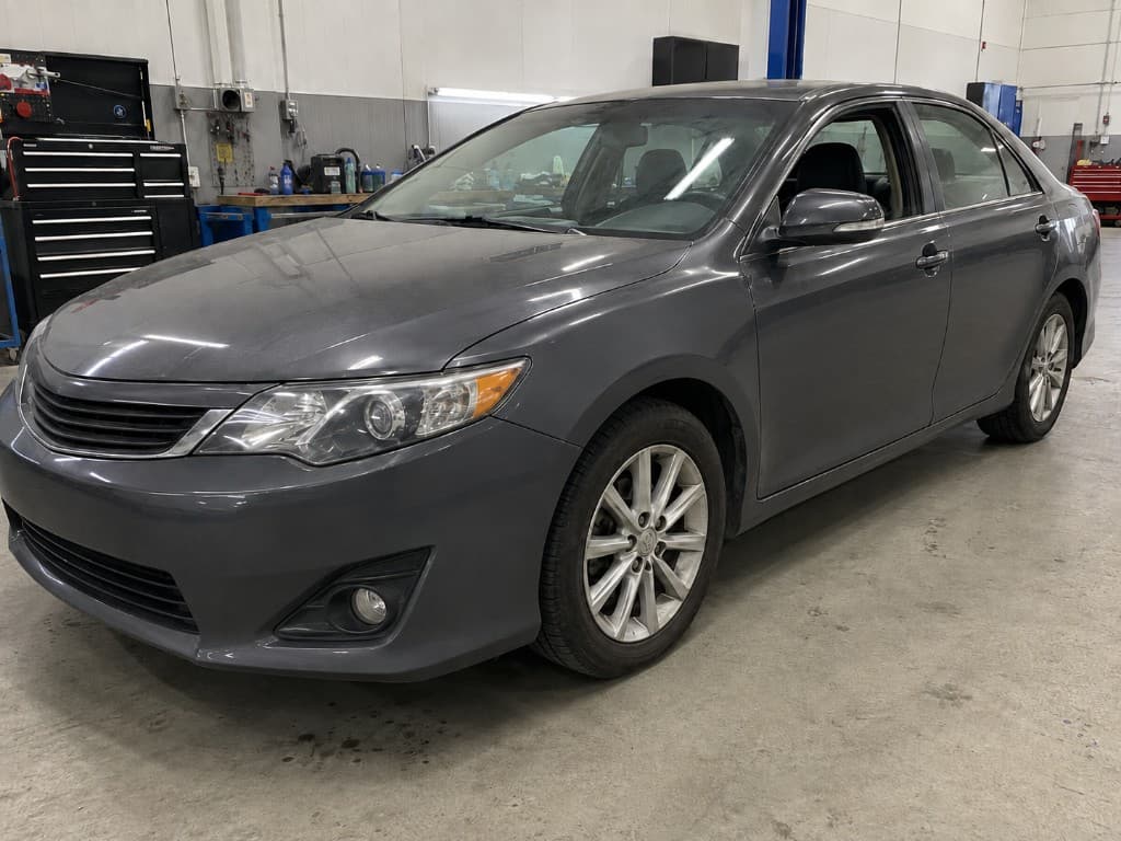 Dark grey sedan with straight panels after dent removal