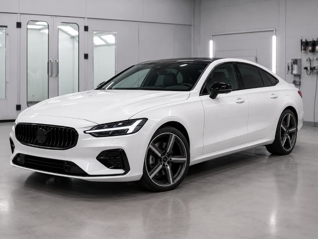 White sedan with a uniform high-gloss finish after a full respray