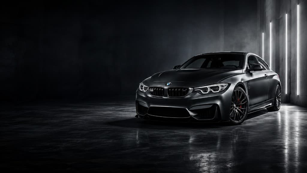 Matte black coupe photographed in a dark studio, representing Maple Refinish Centre finish quality