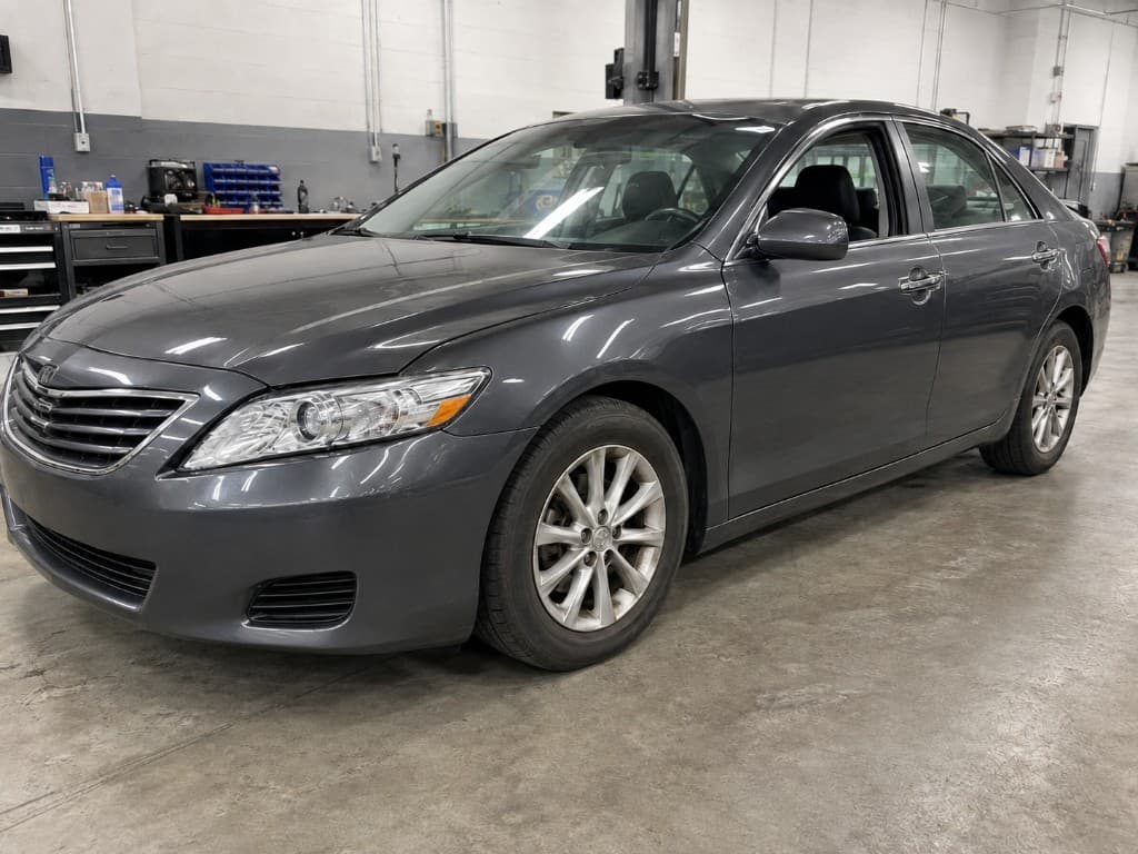 Dark grey sedan with aligned panels and a clean finish after body repair
